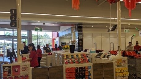 Staff at the cash registers at Coles Flagstone, which opened this morning.