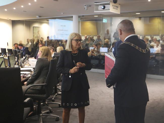 Protestors, including members of the Main beach Asociation, inside Gold Coast City Council objecting to Sunlands Hi Rise proposal at the Spit. Deputy Mayor Donna Gates in last minute talks with the Mayor Tom Tate and Cameron Caldwell before the meeting begins. Picture Glenn Hampson