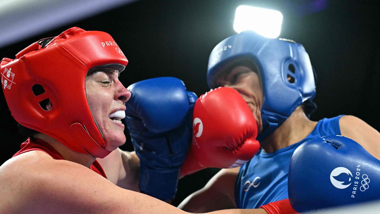 Australia's Caitlin Parker lands a blow on Morocco's Khadija Mardi (blue) in the women's 75kg. Picture: Mohd Rasfan/AFP