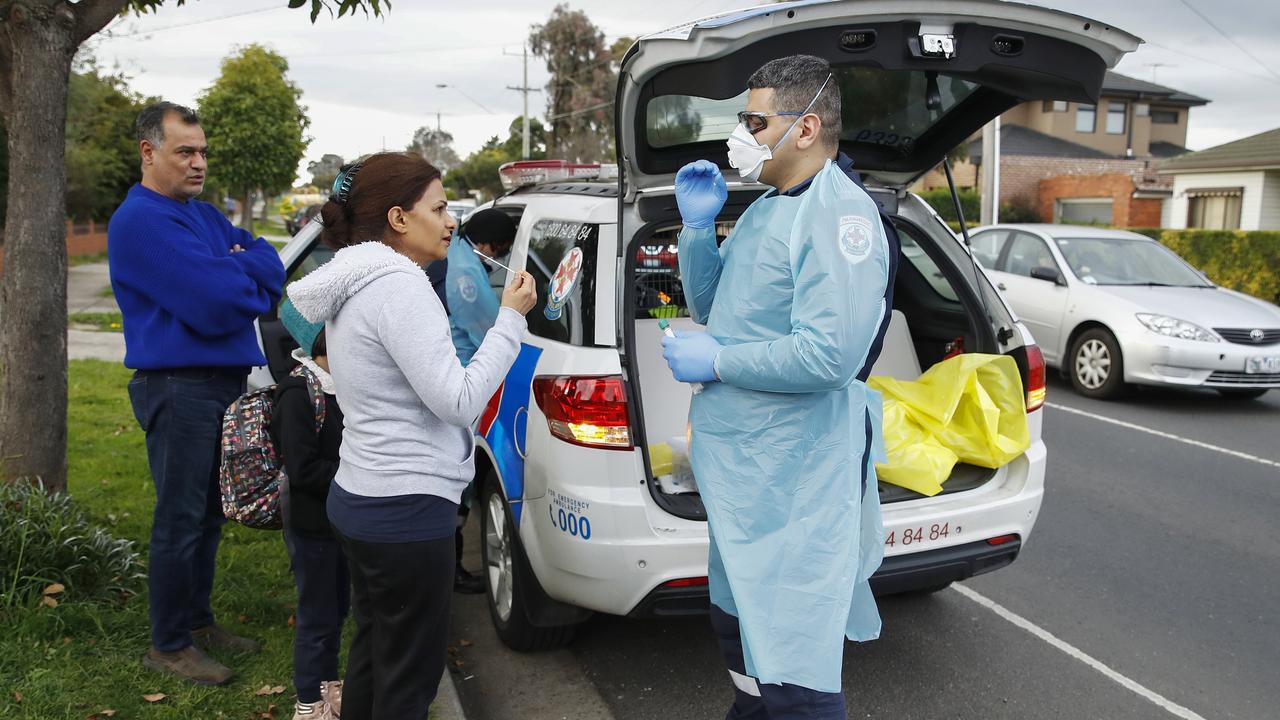 Paramedics perform COVID-19 tests in Broadmeadows, Victoria, this week after knocking on doors to check if people have any symptoms of and would like a test. Picture: AAP Image/Daniel Pockett.