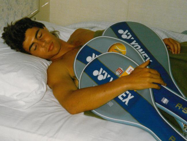 A young Josh Frydenberg takes a nap with his tennis racquets