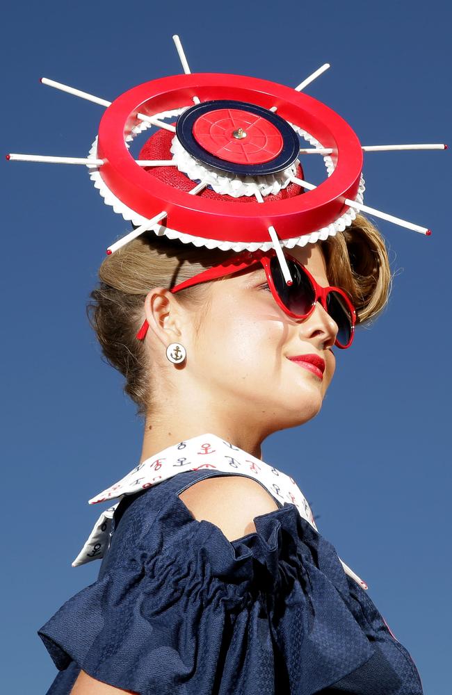 A racegoer poses on Melbourne Cup Day at Flemington Racecourse. Photo by Mark Metcalfe.