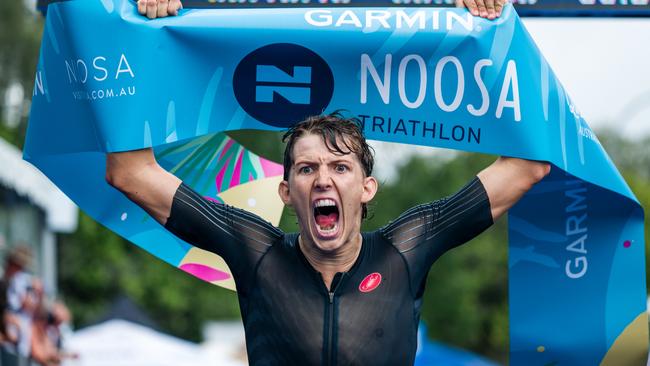 Brayden Mercer crosses the line to record an emotional maiden Noosa Triathlon win. Photo: Alex Polizzi