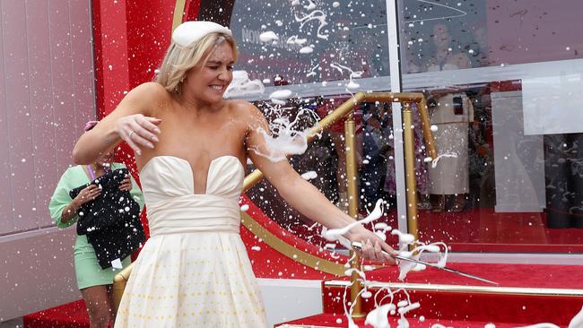 Ariarne Titmus gets covered in champagne in the Flemington Birdcage. Picture: Ian Currie