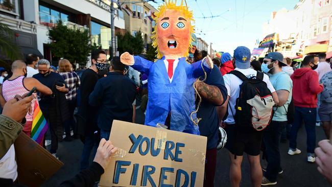 People hold a pinata of US President Donald Trump as they celebrate Joe Biden being elected President. Picture: Josh Edelson/AFP