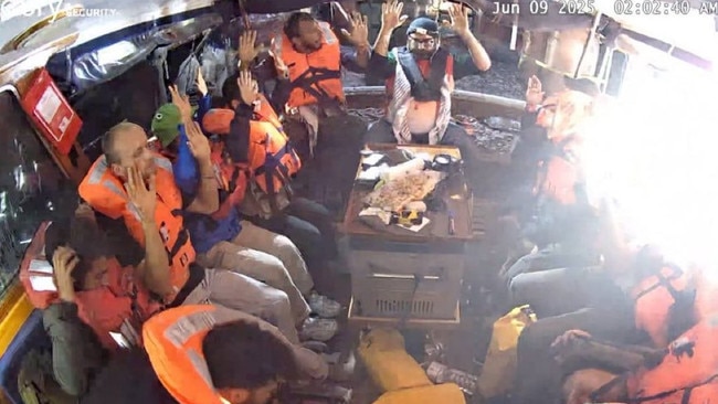 The crew of the Madleen yacht with arms raised as the IDF boarded the vessel.