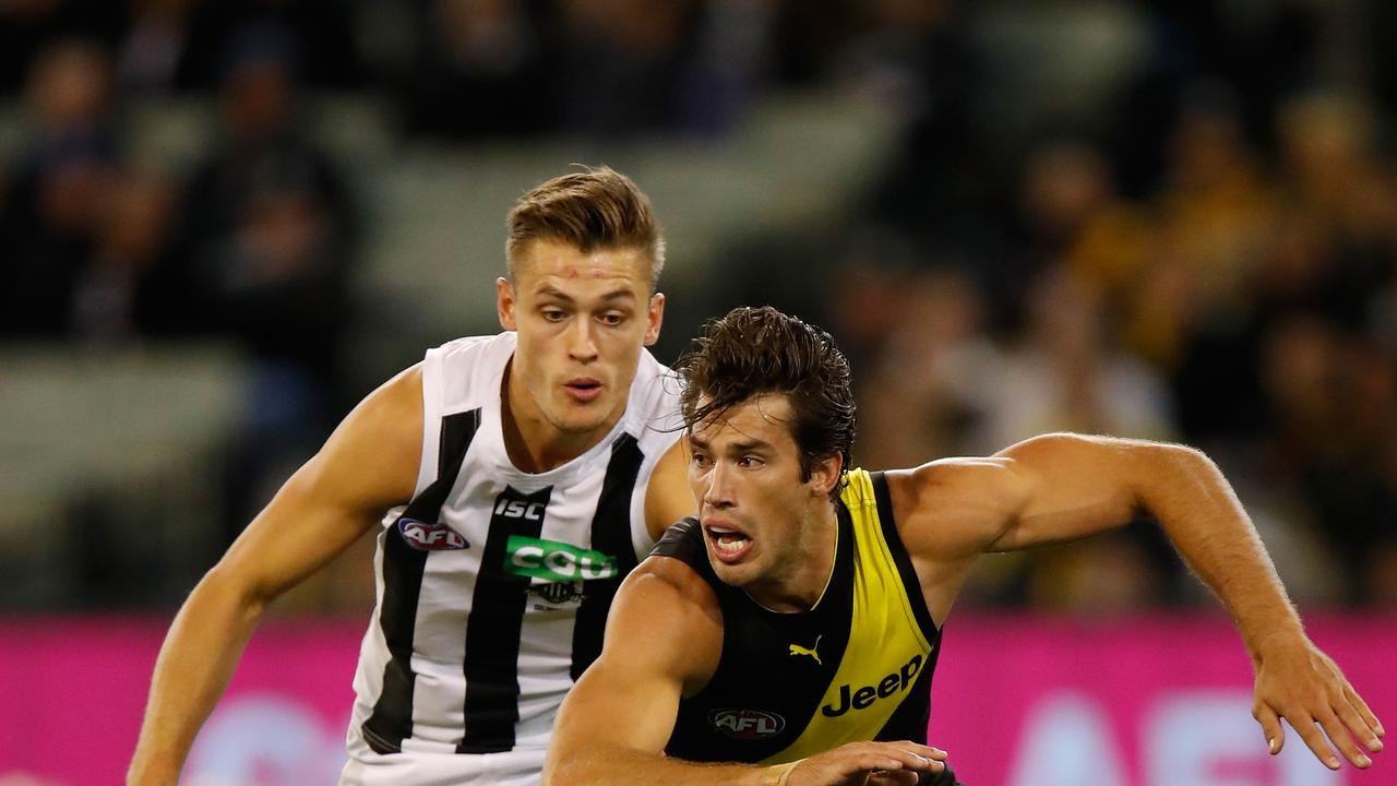 Darcy Moore chases Alex Rance during a game in 2017.