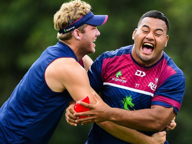 Reds Taniela Tupou (right) and Angus Scott-Young warm up for training at Ballymore. 