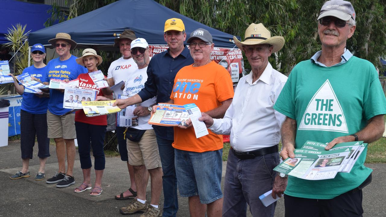 Volunteers hand out how-to-vote cards for various candidates at a voting centre in Cannonvale, Queensland, in 2019.