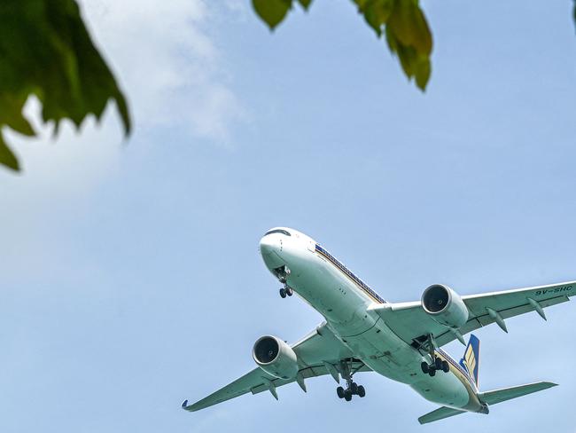 A Singapore Airlines Boeing 737 approaches for landing at Singapore Changi airport in Singapore on November 5, 2024. (Photo by Roslan RAHMAN and ROSLAN RAHMAN / AFP)