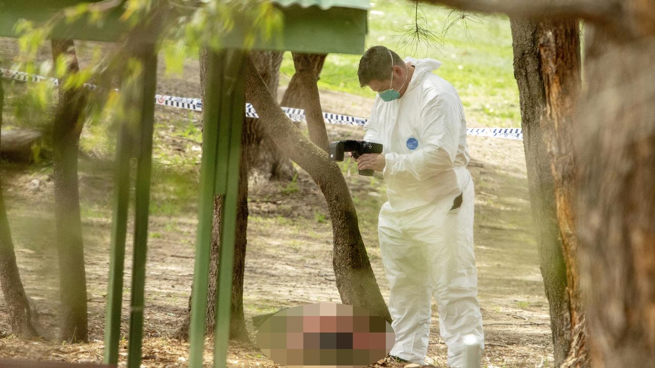 The body of a woman found at Buffalo Creek reserve is photographed by a forensic officer at a playground at Hunters Hill. Picture: Jenny Evans