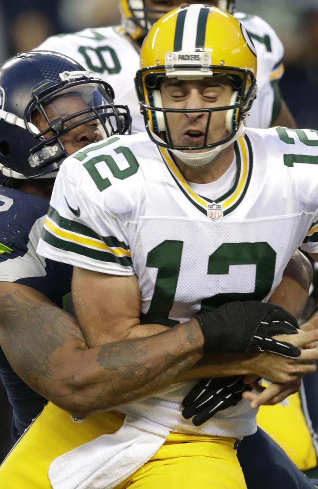 Seattle Seahawks defensive end Michael Bennett forces Green Bay Packers quarterback Aaron Rodgers to fumble in the second half.
