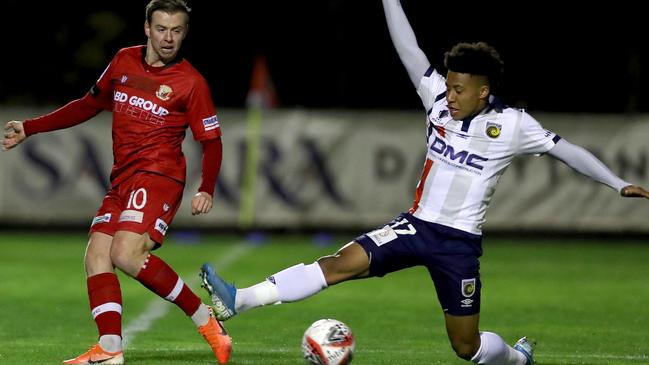 Steven Hewitt squeezes a pass past Samuel Silvera.