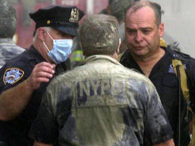 Police officers were covered in dust in the hours after planes flew into the Twin Towers. Picture: Nathan Edwards