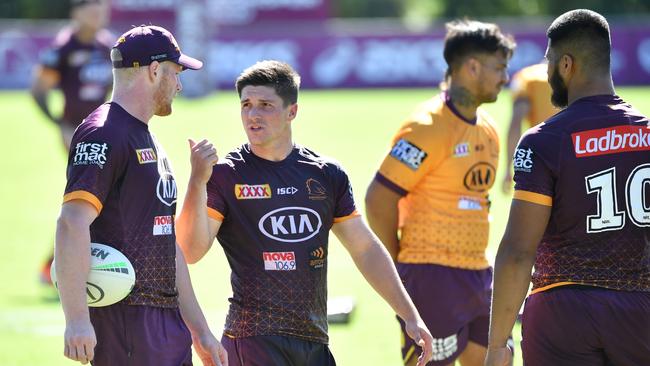 Cory Paix, centre, talks with teammates during a Broncos training session this week