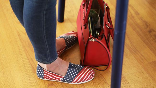 Democratic Congressional candidate Katie Hill fills out her ballot in American flag shoes in California's 25th Congressional district. Picture: AFP.