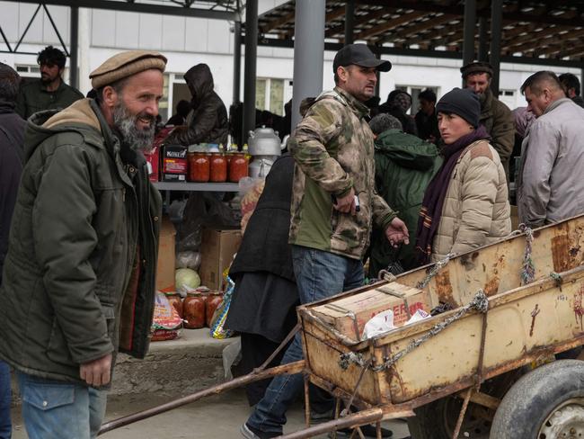 Tajiks and Afghans sell and buy food and household goods at a bazaar in the Tajik town of Kalaikhum on the border with Afghanistan. Picture: AFP