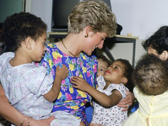 It was a big leap when Princess Diana started cuddling children on her outings as she did here at a Hostel For Abandoned Children In Sao Paulo, Brazil where many had HIV or were suffering with AIDS, which is a cause she championed. Picture: Tim Graham Photo Library via Getty Images