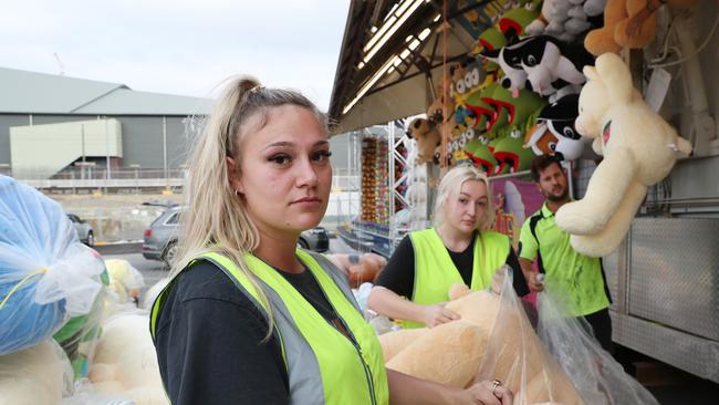 Savanah Fisher, 25, packing up the games in Sideshow Alley after the Ekka was cancelled due to Covid-19. Picture: Liam Kidston.