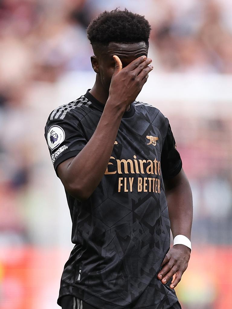 Bukayo Saka looks dejected on the pitch against West Ham. Photo by Alex Pantling/Getty Images.