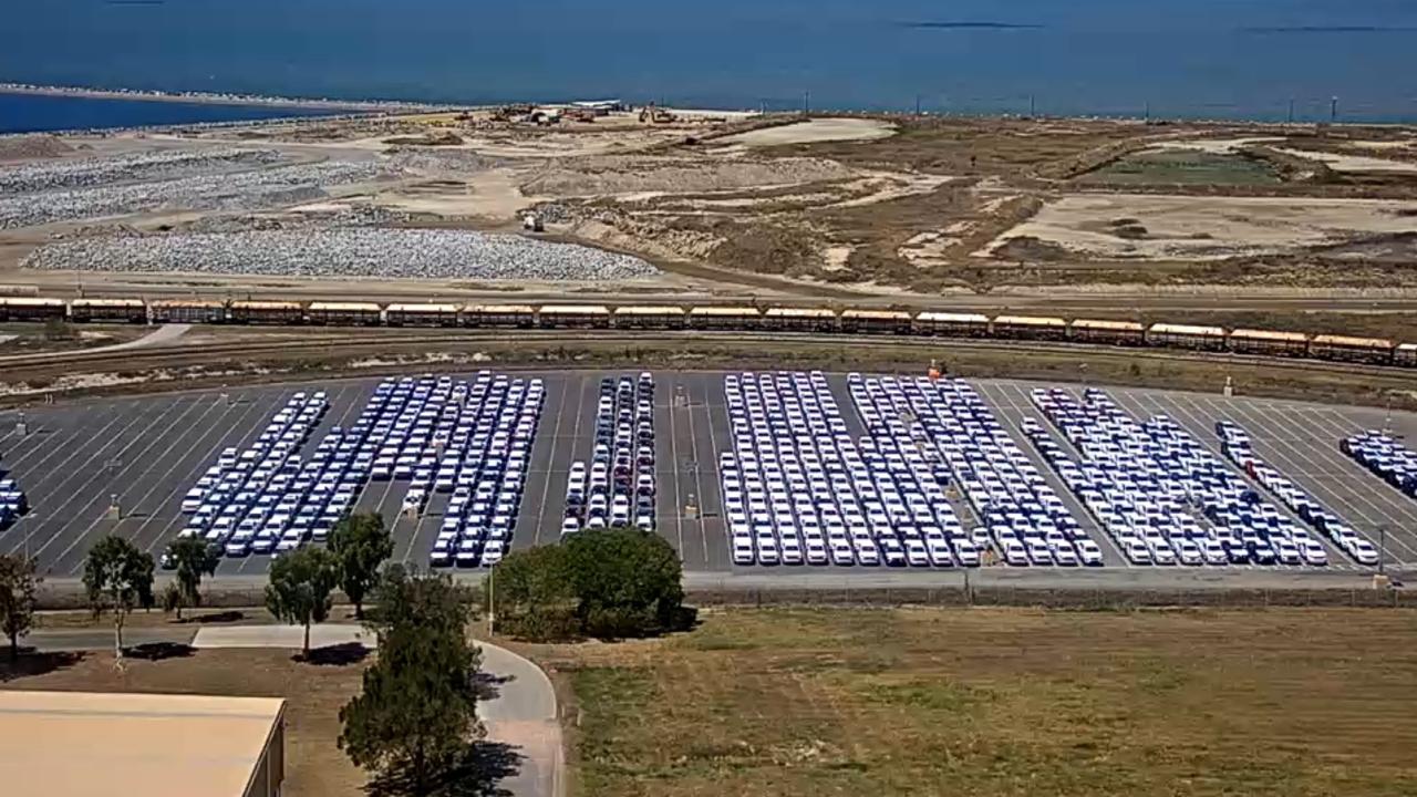 An aerial view showing cars parked at Townsville port ready for delivery to car dealers across northern Australia.