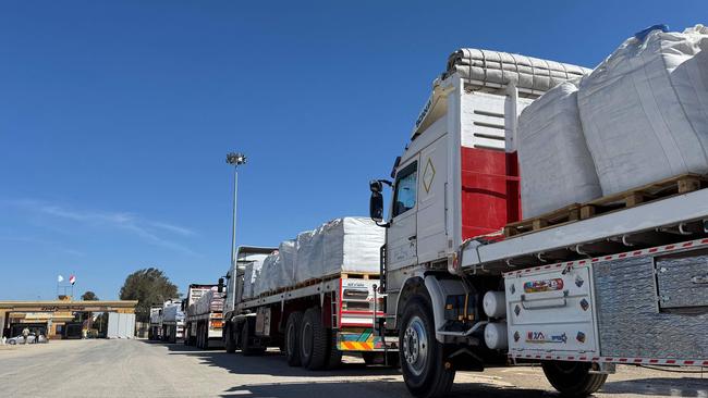 Trucks carrying humanitarian aid line up on the Egyptian side of the Rafah border crossing with the Gaza Strip on March 2. Picture: AFP