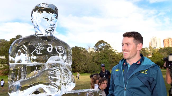 Australian rugby player Bernard Foley poses next to an ice sculpture of himself.