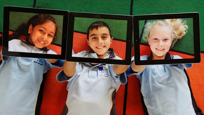 Kids having fun with iPads at school. The technology is there, whether we like it or not, so it really a good idea to take it away? Picture: Toby Zerna