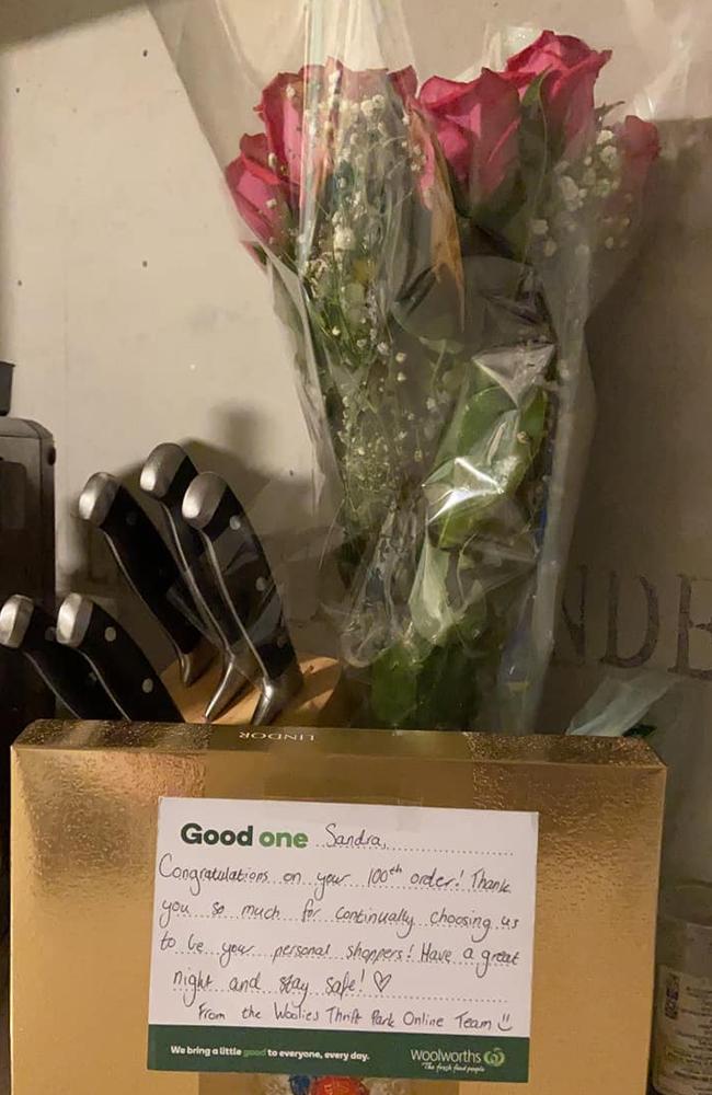 A Melbourne woman shared a photo on Facebook of a bunch of flowers and a box of chocolates she received from her local Woolies store for placing her 100th order. Picture: Facebook