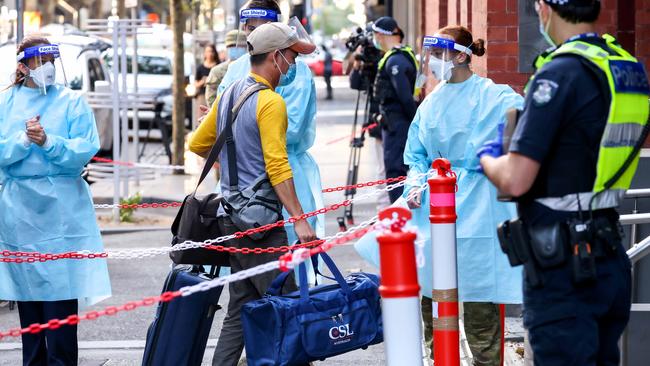 A returned travellers arrives at the InterContinental Hotel in Melbourne for their 14 day quarantine period. Picture : Ian Currie