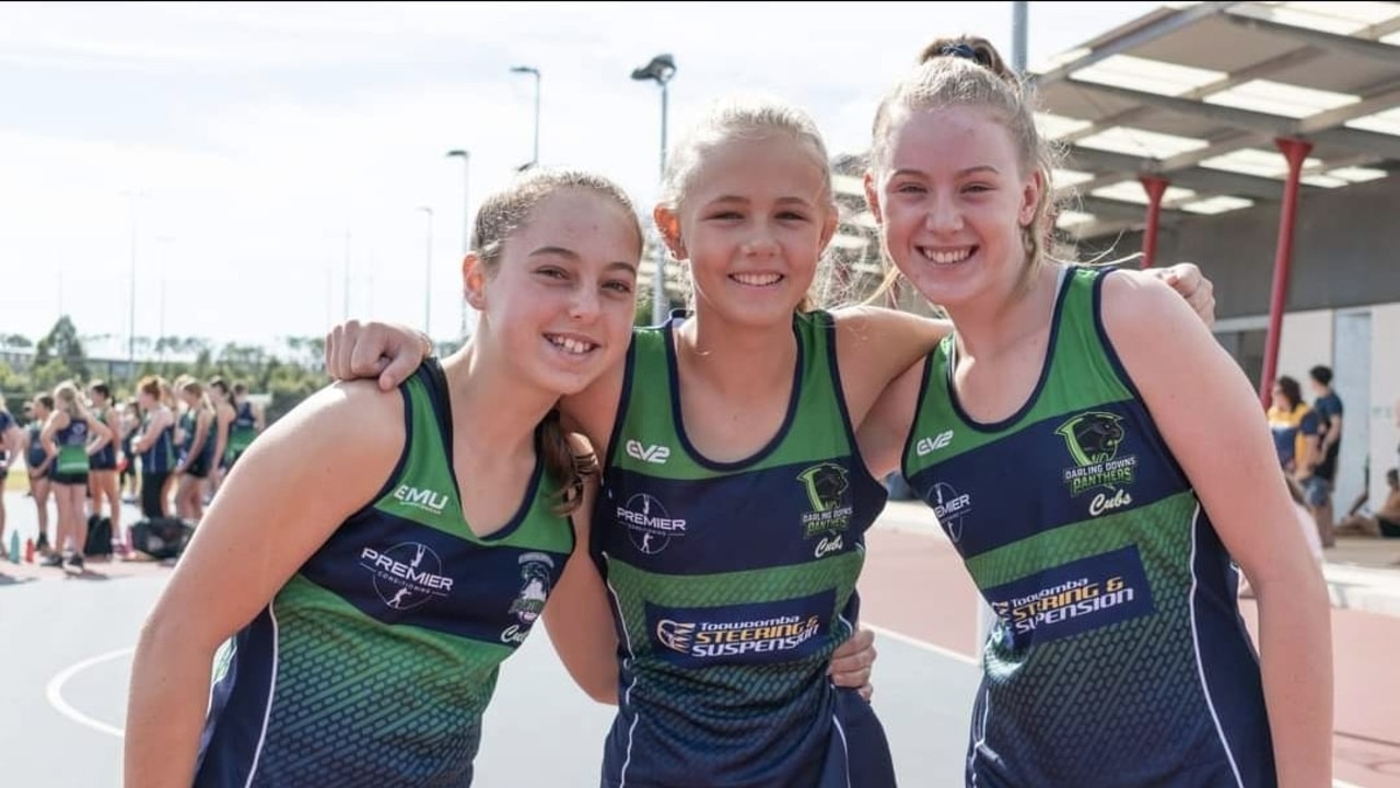 Young Darling Downs Panthers players (from left) Kenzie van Zandbergen, Anna Saal and Lainey Currie line up before a match in 2021.