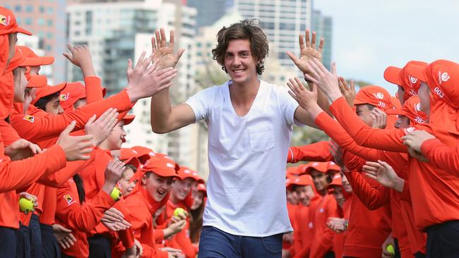 Tennis Australia announce initiatives for Australian Open 2016 at Birrarung Marr. Thanasi Kokkinakis gets a high five from 101 ballkids through Birrarung Marr. Picture: Alex Coppel.