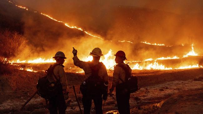 Fire crews battle the Kenneth Fire in the West Hills section of Los Angeles, Thursday, Jan. 9, 2025. (AP Photo/Ethan Swope)