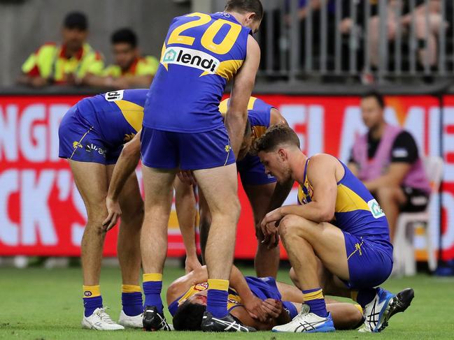 Tom Cole lies on the ground after clashing heads with Josh Rotham. (Photo by Will Russell/AFL Photos via Getty Images)