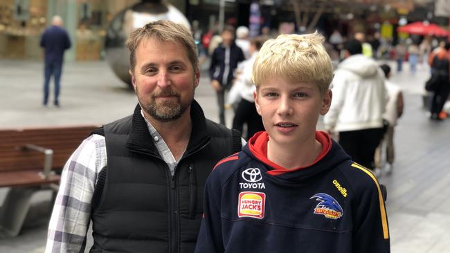 Crows diehards Bernie Watson, 14 and dad Shaun, 45 travelled from Naracoorte for the match. Picture: Shashi Baltutis