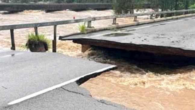 Ollera Creek Bridge cut in half from flood water on the Bruce Highway north of Townsville.