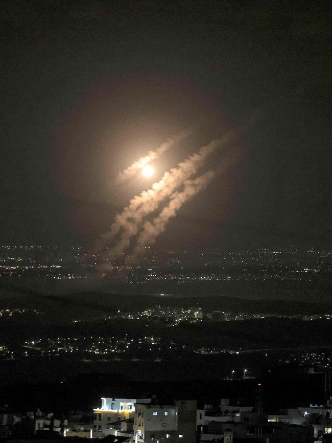 This picture taken from the West Bank city of Hebron shows projectiles above the Israeli city of Ashdod during missile attack. Picture: Hazem Bader/AFP