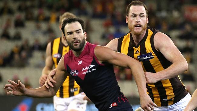 Lewis in action for Melbourne against Roughead and the Hawks. Picture: Wayne Ludbey