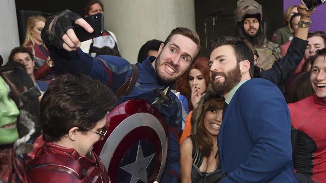 Chris Evans takes a selfie with a fan as he arrives at the premiere this week. Picture: Chris Pizzello/Invision/AP