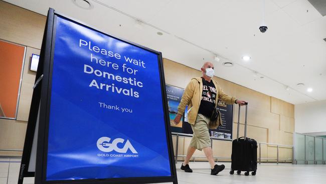 Passengers arrive off the flight from Adelaide into the Gold Coast before the border closes to South Australia from midnight. Picture: Scott Powick.