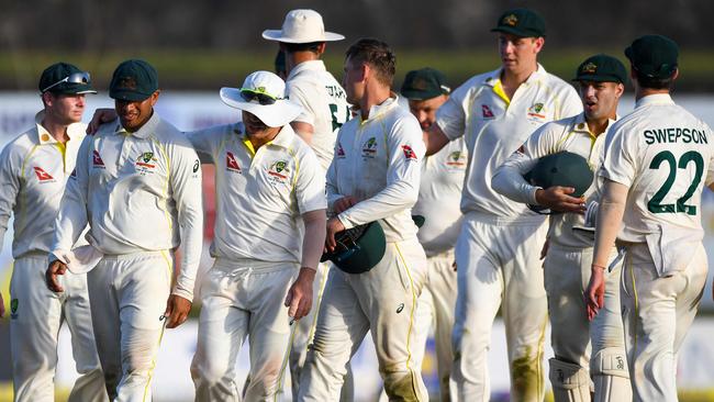 Australia’s cricketers walk back to the pavilion after one of the more remarkable days in Test cricket. Picture: AFP