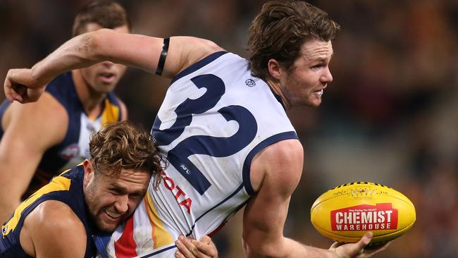 PERTH, AUSTRALIA - JULY 11: Patrick Dangerfield of the Crows looks to handball while being tackled by Mark Hutchings of the Eagles during the round 15 AFL match between the West Coast Eagles and the Adelaide Crows at Domain Stadium on July 11, 2015 in Perth, Australia. (Photo by Paul Kane/Getty Images)