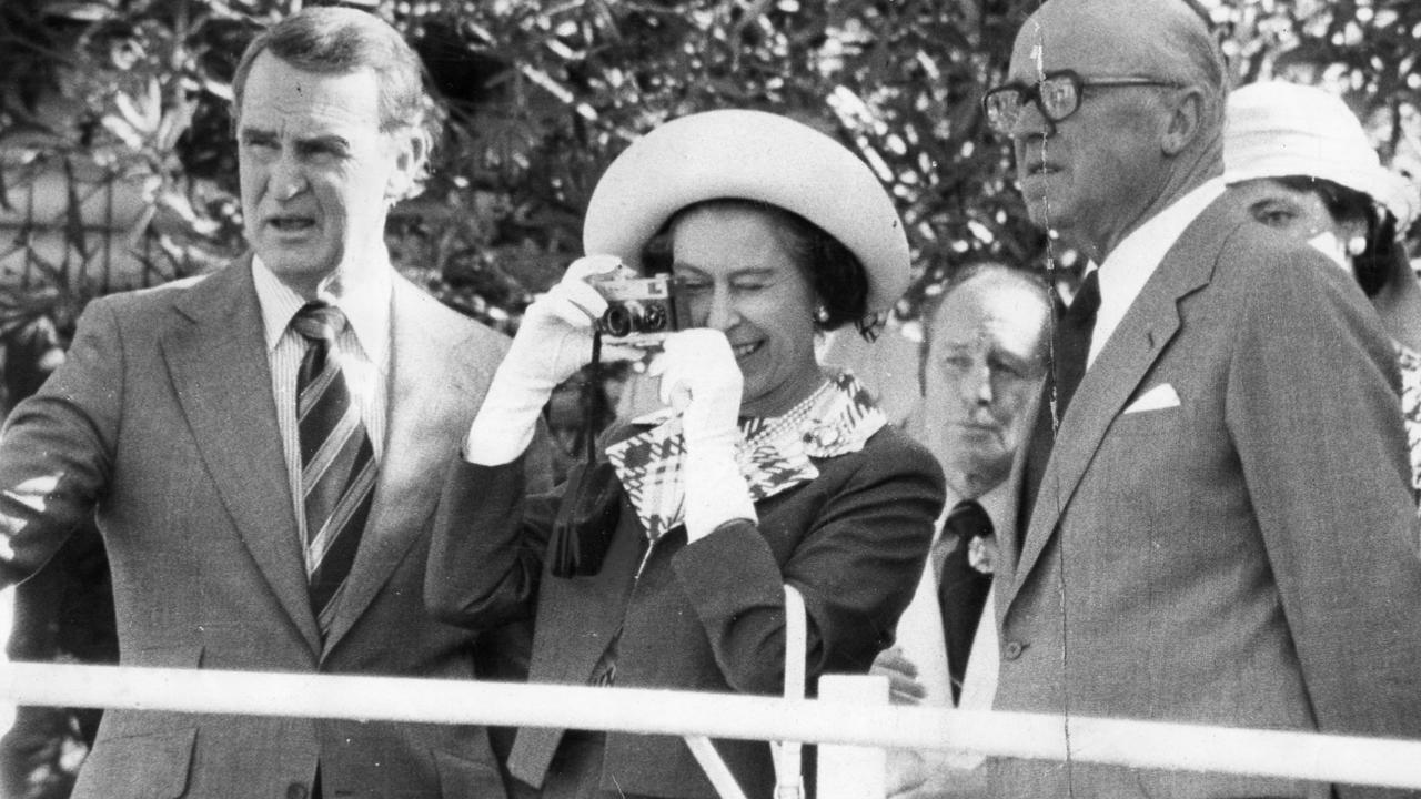 The Queen with racehorse owner-trainer Colin Hayes (left) photographing the horse Without Fear at Lindsay Park stud, Angaston.