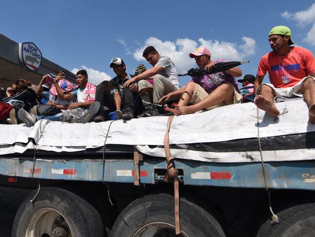 Honduran migrants heading to the United States with a second caravan travel aboard a truck in Escuintla department, 50 km south of Guatemala City, on January 17. Picture: Johan Ordonez/AFP