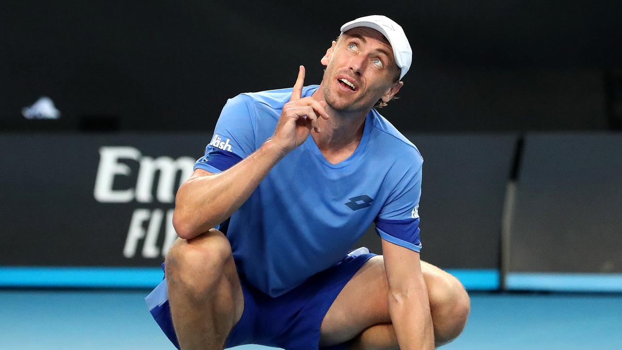 You had one job, John Millman is saying to John McEnroe, probably. (Photo by Kelly Defina/Getty Images)