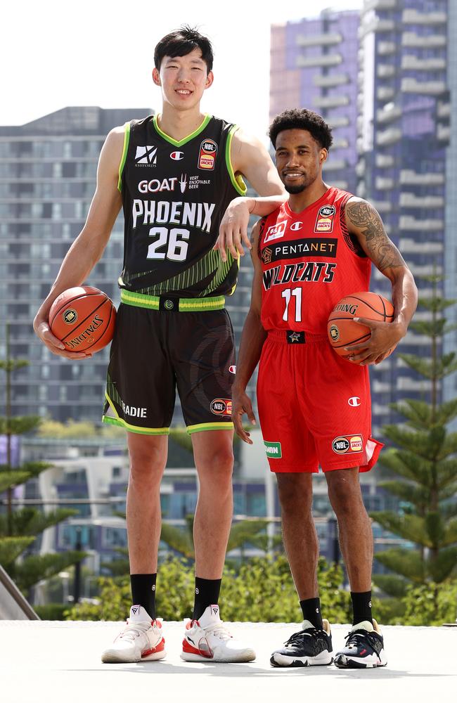 There is a 33cm height difference between South East Melbourne giant Zhou Qi and Perth Wildcats jet Bryce Cotton. Picture: Michael Klein