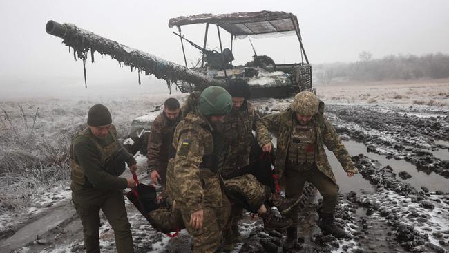 Ukrainian tank crews practise the evacuation of a comrade in freezing conditions near the frontline in the Donetsk region this month. Picture: AFP