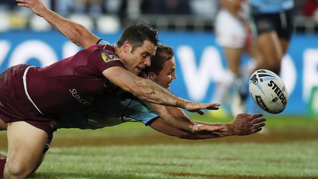 Matt Moylan taps it dead ahead of Queensland's Cooper Cronk. Picture: Phil Hillyard