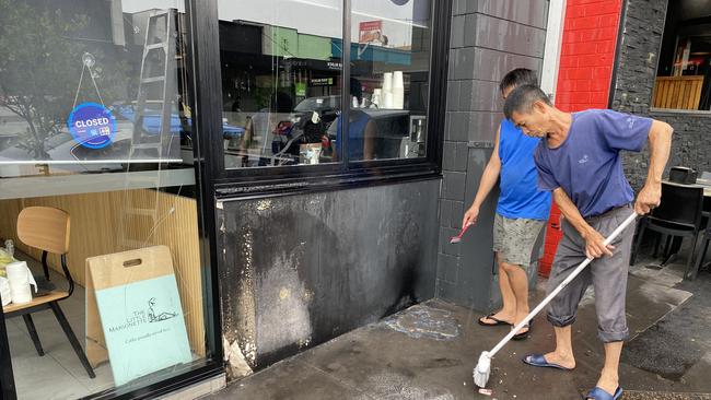 Smashed glass and burns to the exterior of Saigon Hustle restaurant. Picture: Kirsten Jelinek