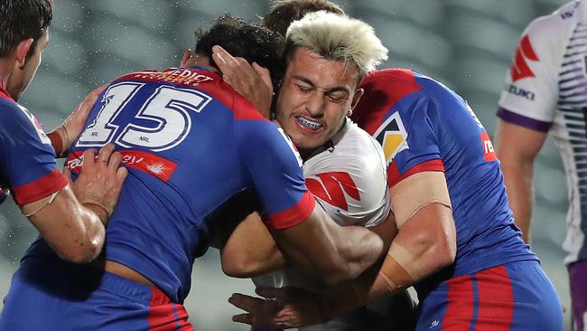 GOSFORD, AUSTRALIA - JUNE 13: Tino Faasuamaleaui of the Storm is tackled during the round five NRL match between the Newcastle Knights and the Melbourne Storm at Central Coast Stadium on June 13, 2020 in Gosford, Australia. (Photo by Matt King/Getty Images)